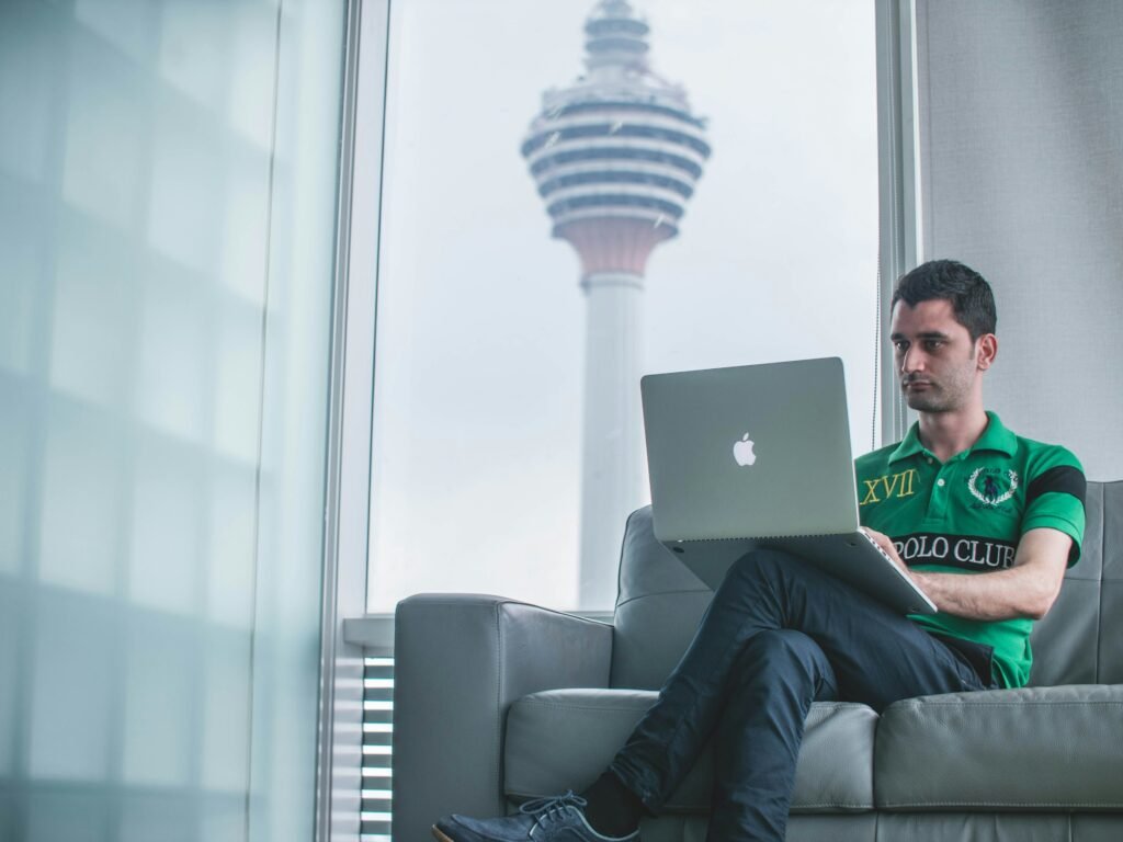 Man working on a computer illustrating a report from the Tony Blair Institute highlighting AI's potential impact on the workforce, including the opportunities and risks to the labor market and how government and policymakers can mitigate the challenges.